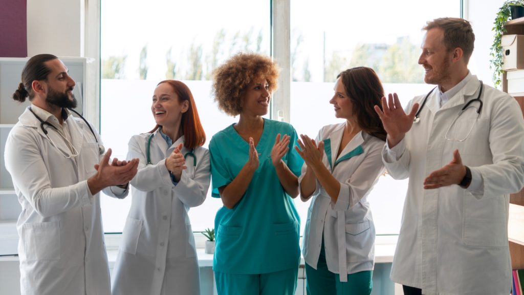 Clinic staff celebrating improved efficiency using Medi-EHR EHR software