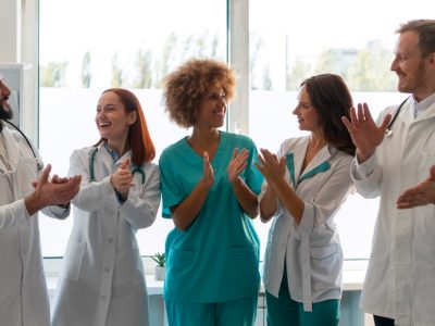 Clinic staff celebrating improved efficiency using Medi-EHR EHR software