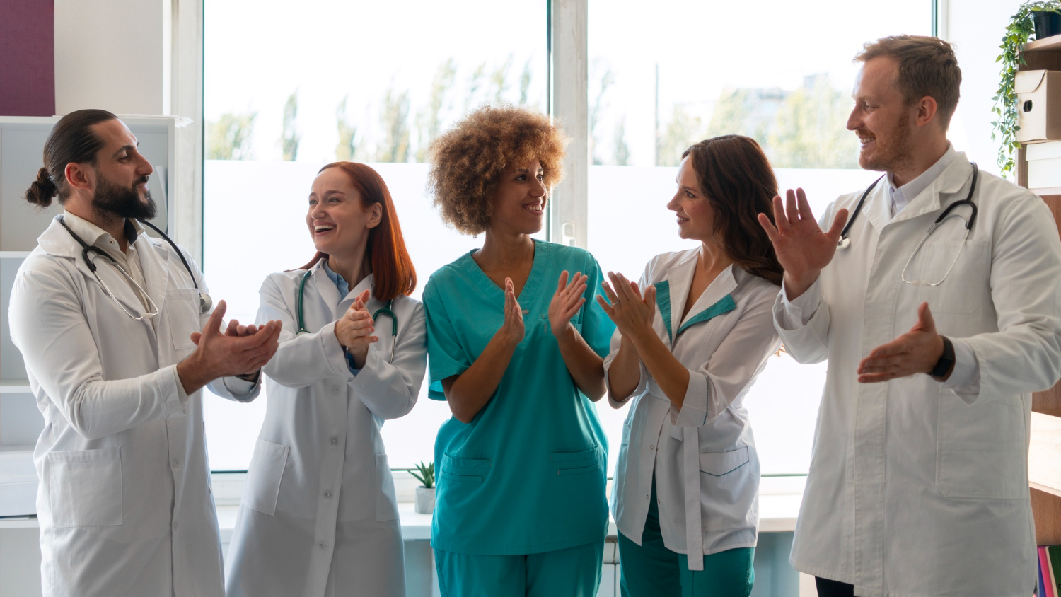 Clinic staff celebrating improved efficiency using Medi-EHR EHR software