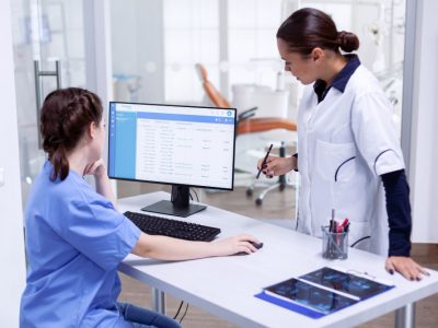 Doctor managing patient records using Medi-EHR EMR and practice management system.