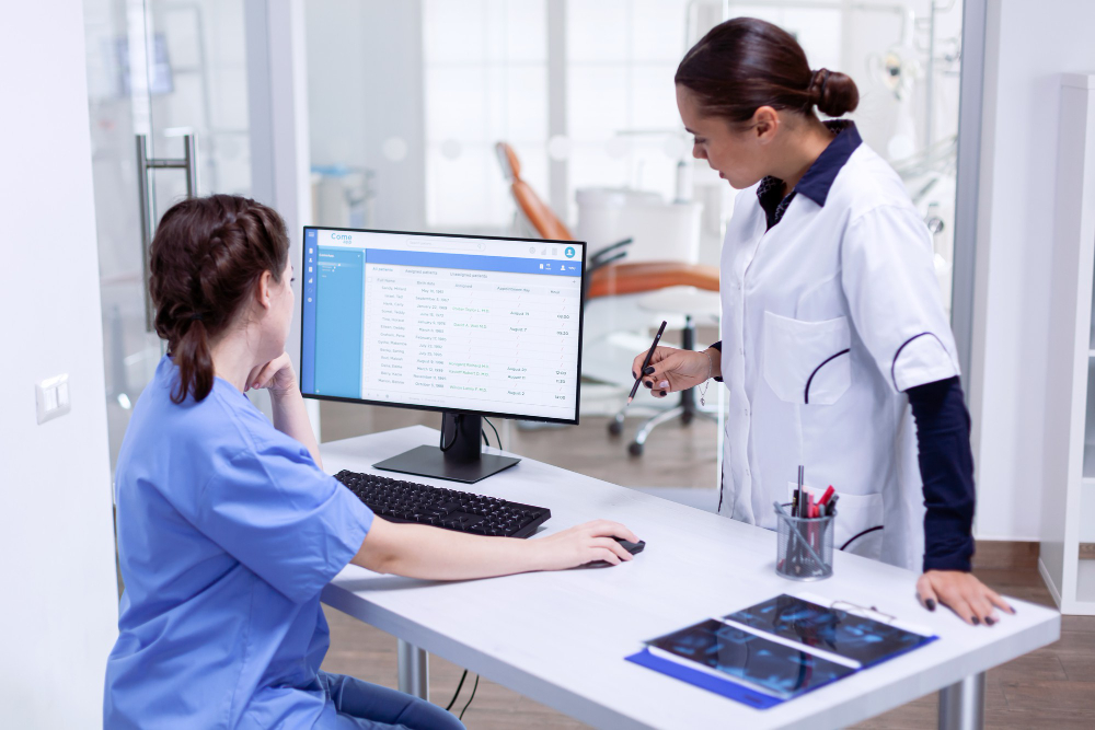 Doctor managing patient records using Medi-EHR EMR and practice management system.