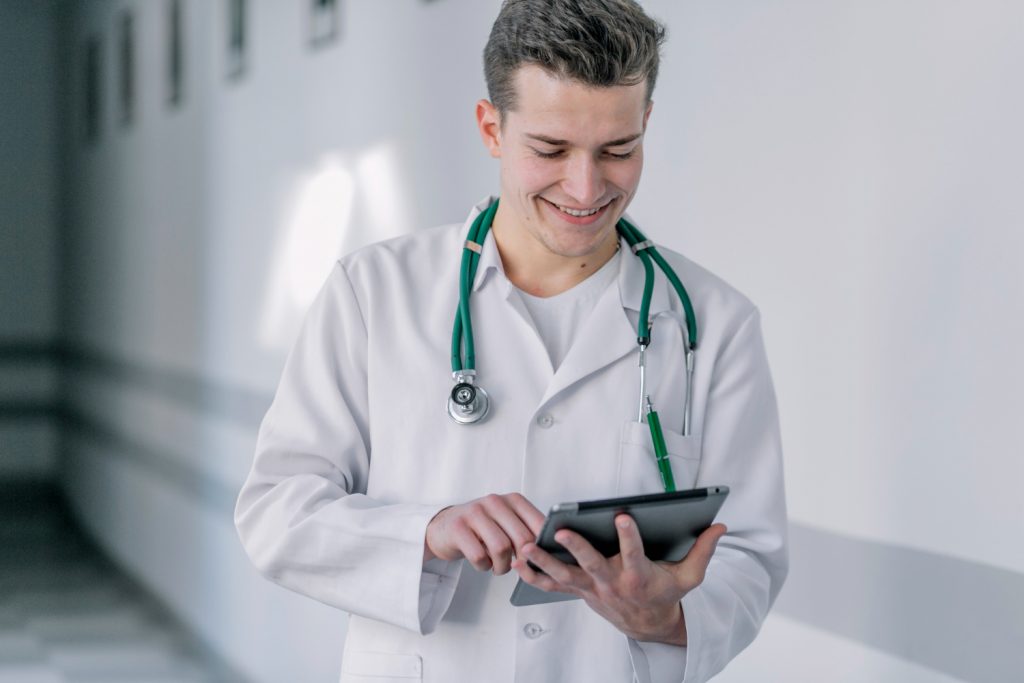 Doctor using Medi EHR software on tablet for patient charting
