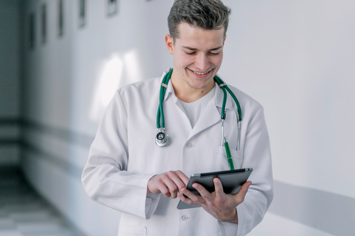 Doctor using Medi EHR software on tablet for patient charting
