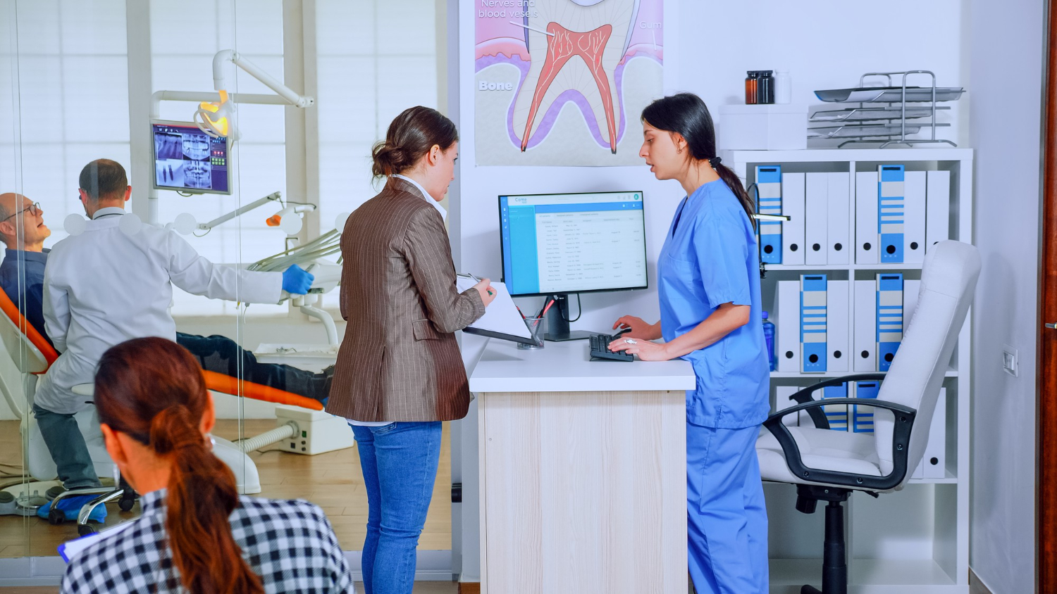 Patient checking in using Medi-EHR kiosk EHR system at clinic front desk.